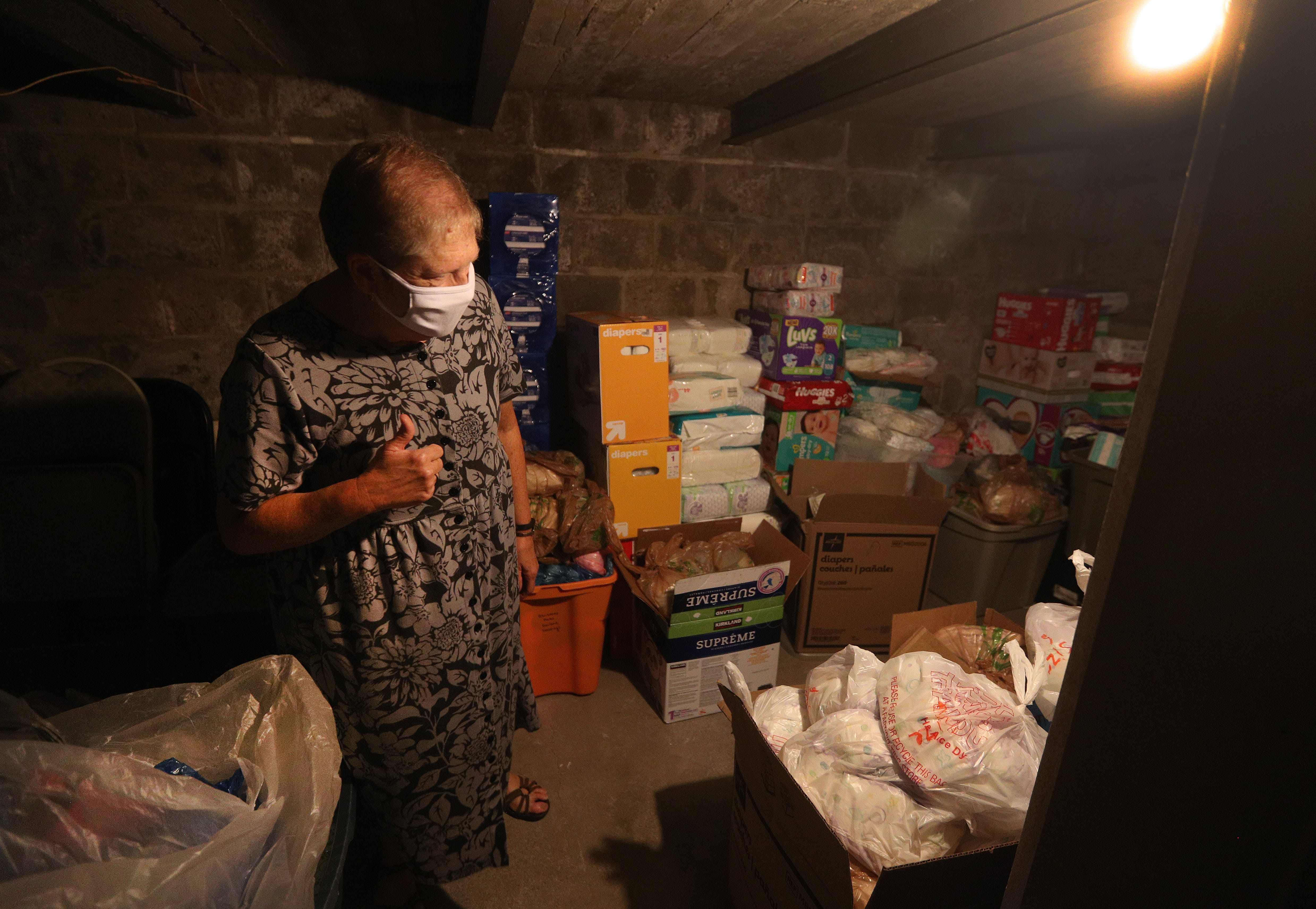 Sister Karen Dietz, interim director of Bethany House, looks over items stored in the basement of the building. It is one of the few food shelves that hands out diapers and other personal care items.