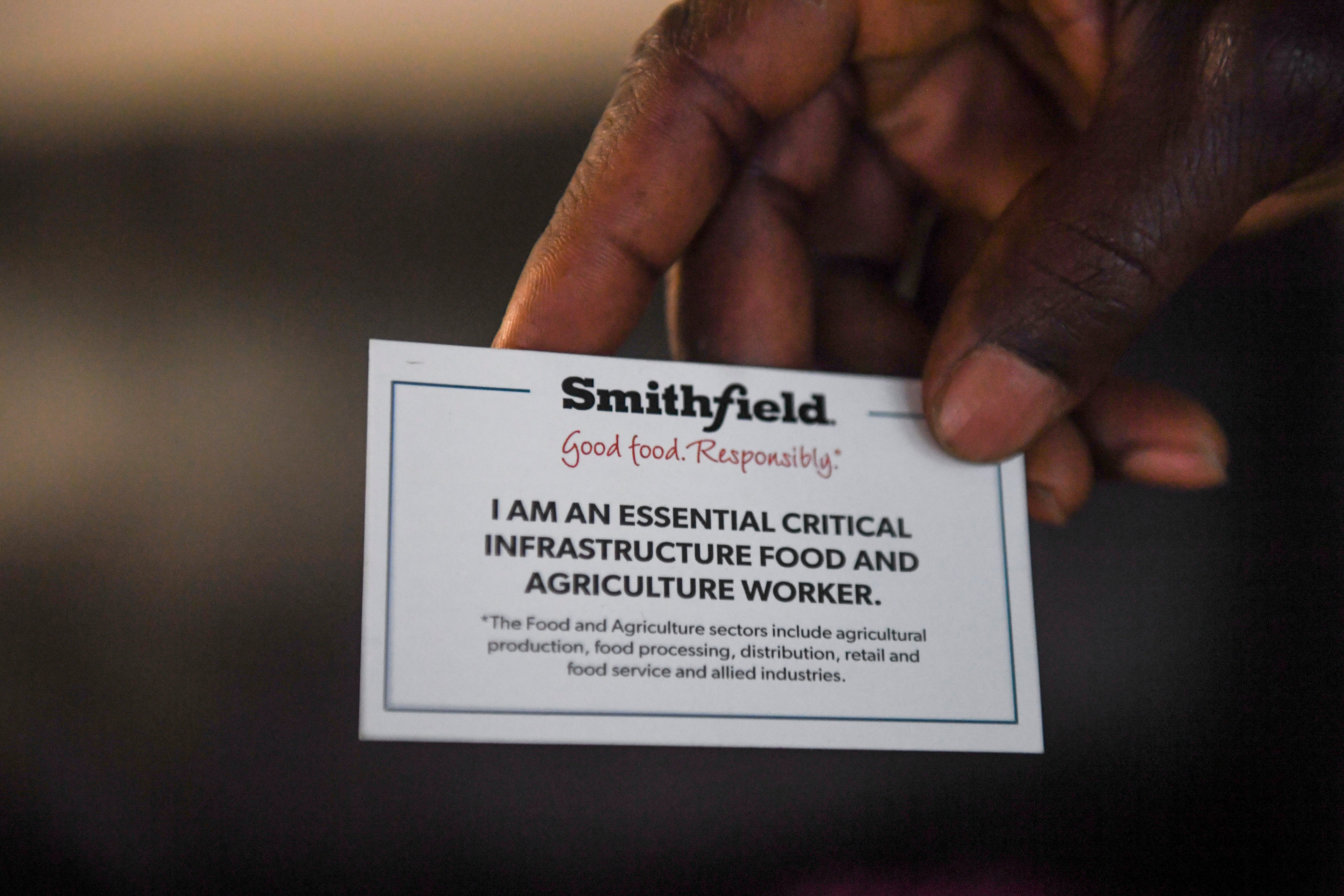 John Deranamie holds a card given to him and his wife, Marie Cole, from Smithfield on Wednesday, April 29, 2020 at his home in Sioux Falls, S.D. Smithfield Foods workers are deemed essential since the company is the world's largest pork producer. 