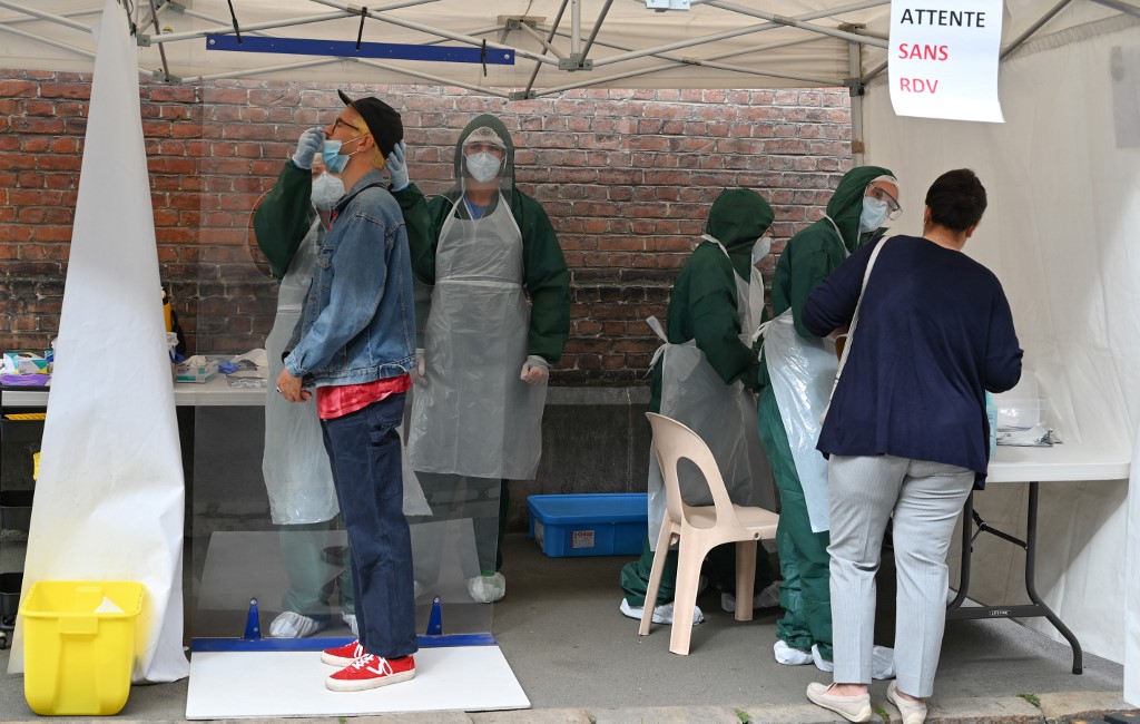 A biologist from the Institut Pasteur de Lille takes a swab sample from a man testing for the novel coronavirus COVID-19 in Lille, northern France, as city of Lille, a bustling hub close to the Belgian border, has been the subject of particular concern with the prevalence of the virus doubling to 38 people per 100,000 in just two weeks. - France, which has registered over 30,000 deaths from the COVID-19 epidemic, recorded thousands of new confirmed infections last week, prompting some regions to reimpose local restrictions. (Photo by DENIS CHARLET / AFP)