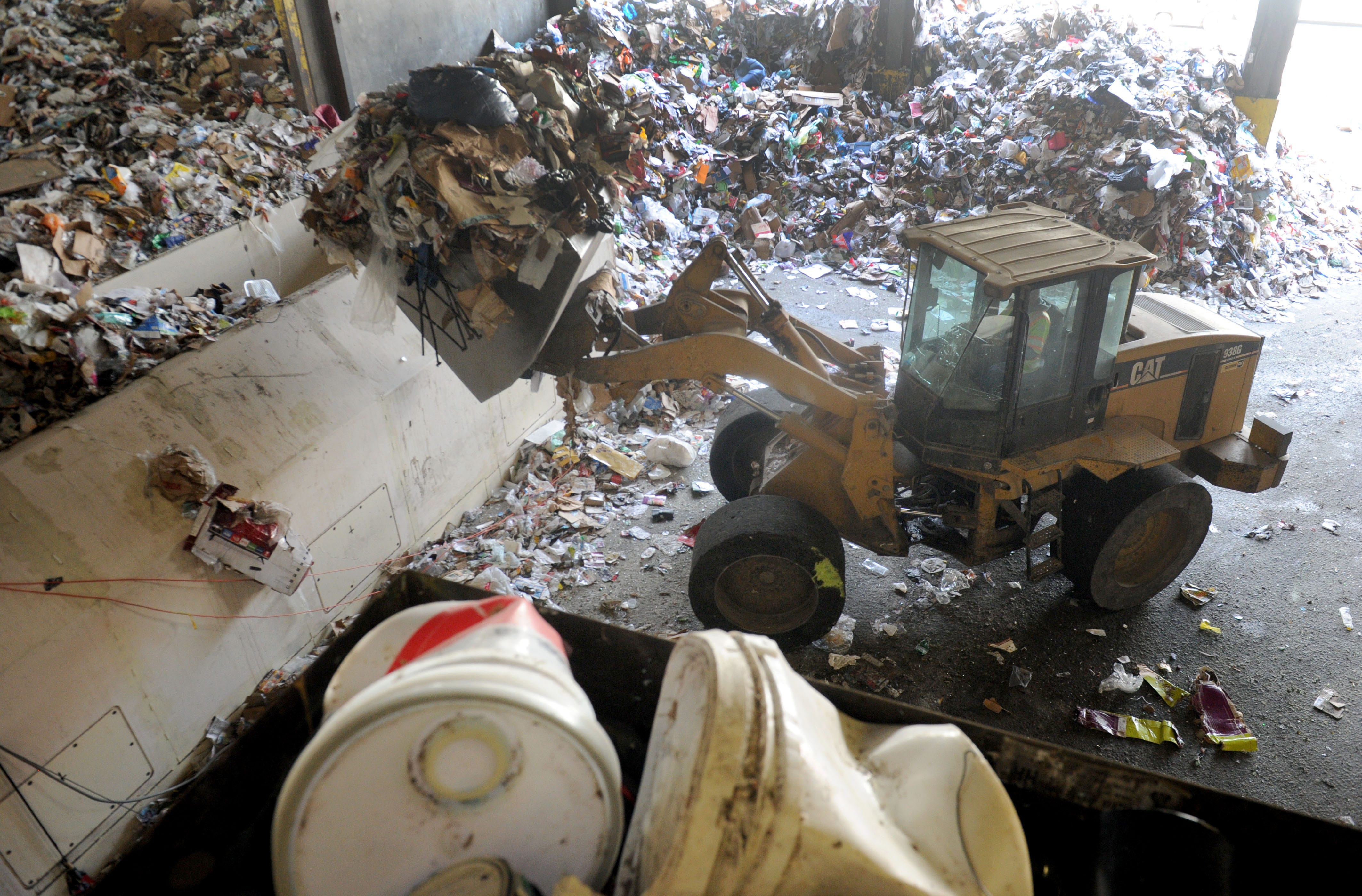 Recyclables are scooped up and loaded recently at Gold Coast Recycling in Ventura, where new sorting equipment that makes operations more efficient.