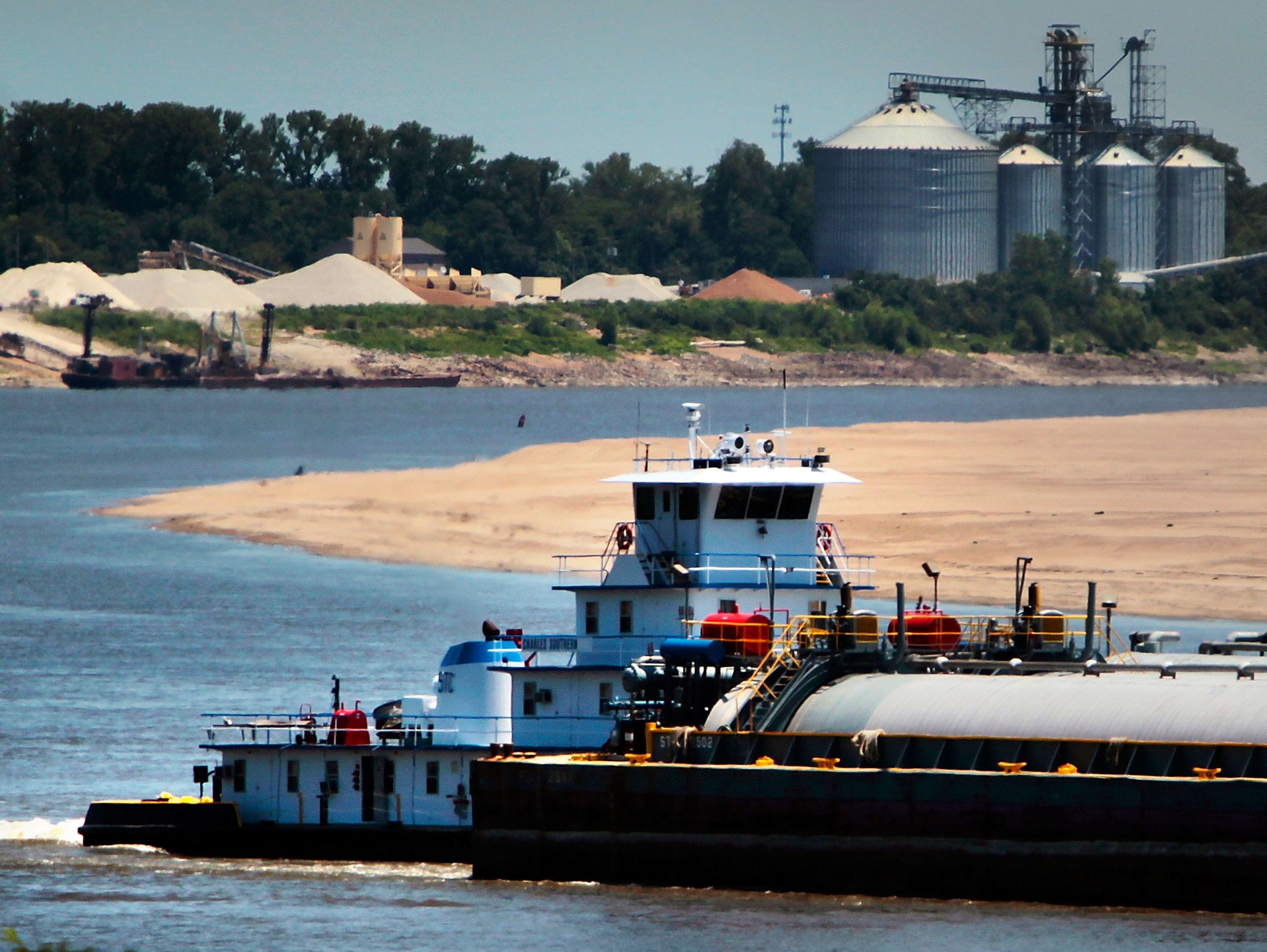 Barge traffic passes down the Mississippi River on June 27, 2012.
