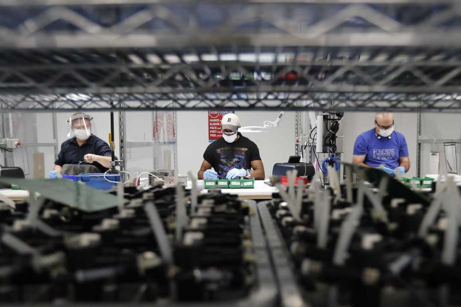 FILE - In this May 13, 2020, file photo, Ford Motor Co., line workers put together ventilators that the automaker is assembling at the Ford Rawsonville plant in Ypsilanti Township, Mich. American industry rebounded last month as factories began to reopen for the first time since being shut down by the coronavirus in Aprll. The Federal Reserve said Tuesday, June 16, 2020, that industrial production — including output at factories, mines and utilities — rose 1.4% in May after plummeting a record 12.4% in April and 4.6% in March. Photo: Carlos Osorio, AP / Copyright 2020 The Associated Press. All rights reserved.