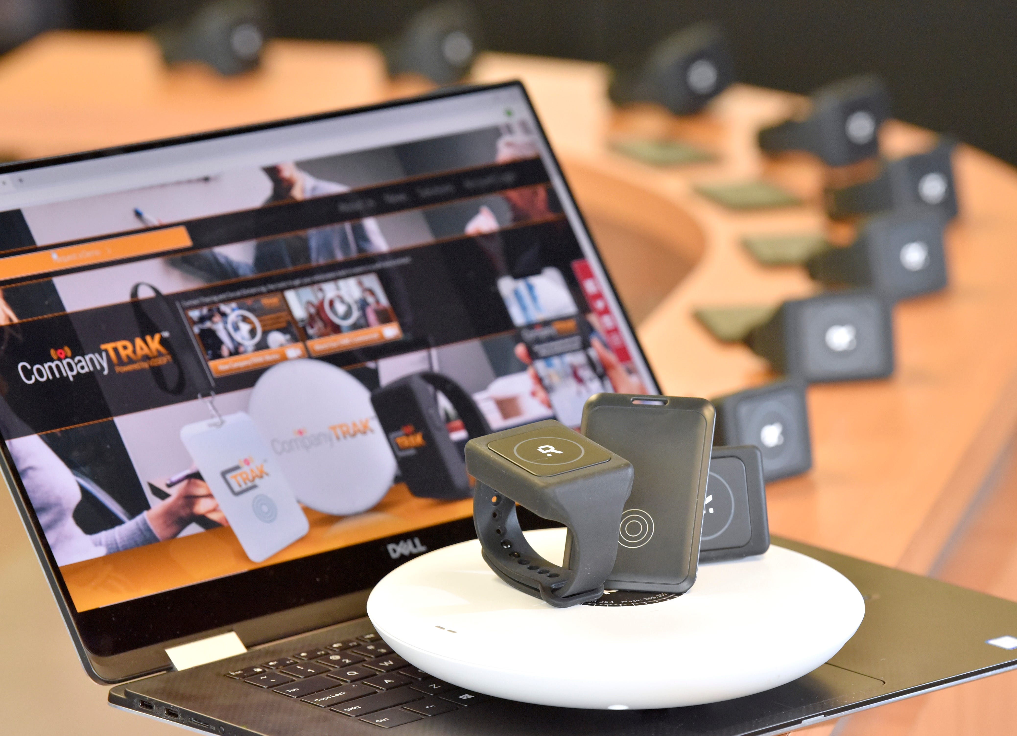 CompanyTRAK.com homepage is displayed with wristband devices, bluetooth tags and a bluetooth scanner that are used for contract tracing and social distancing.