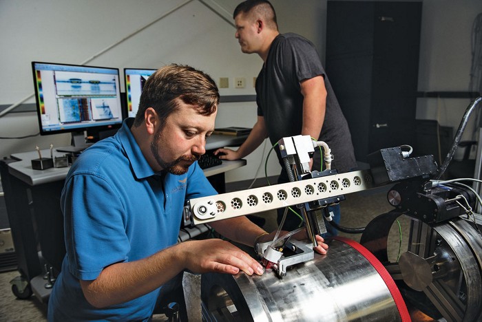 A photo of two researchers working in a lab. 09836-cover-nde.jpg
