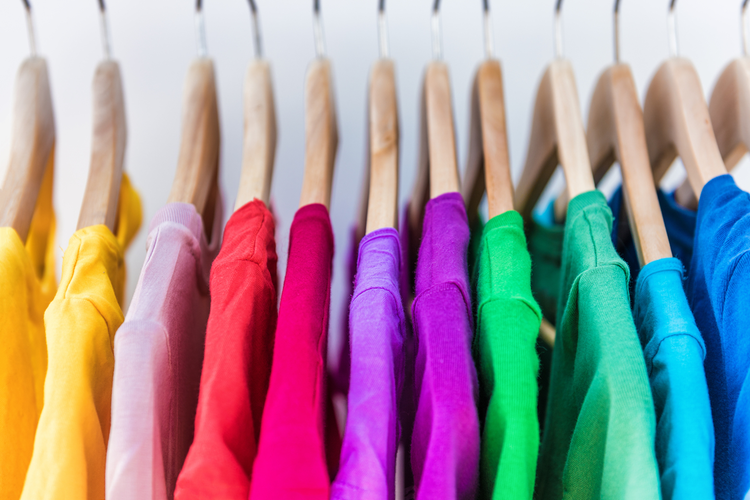row of colorful shirts on hangers