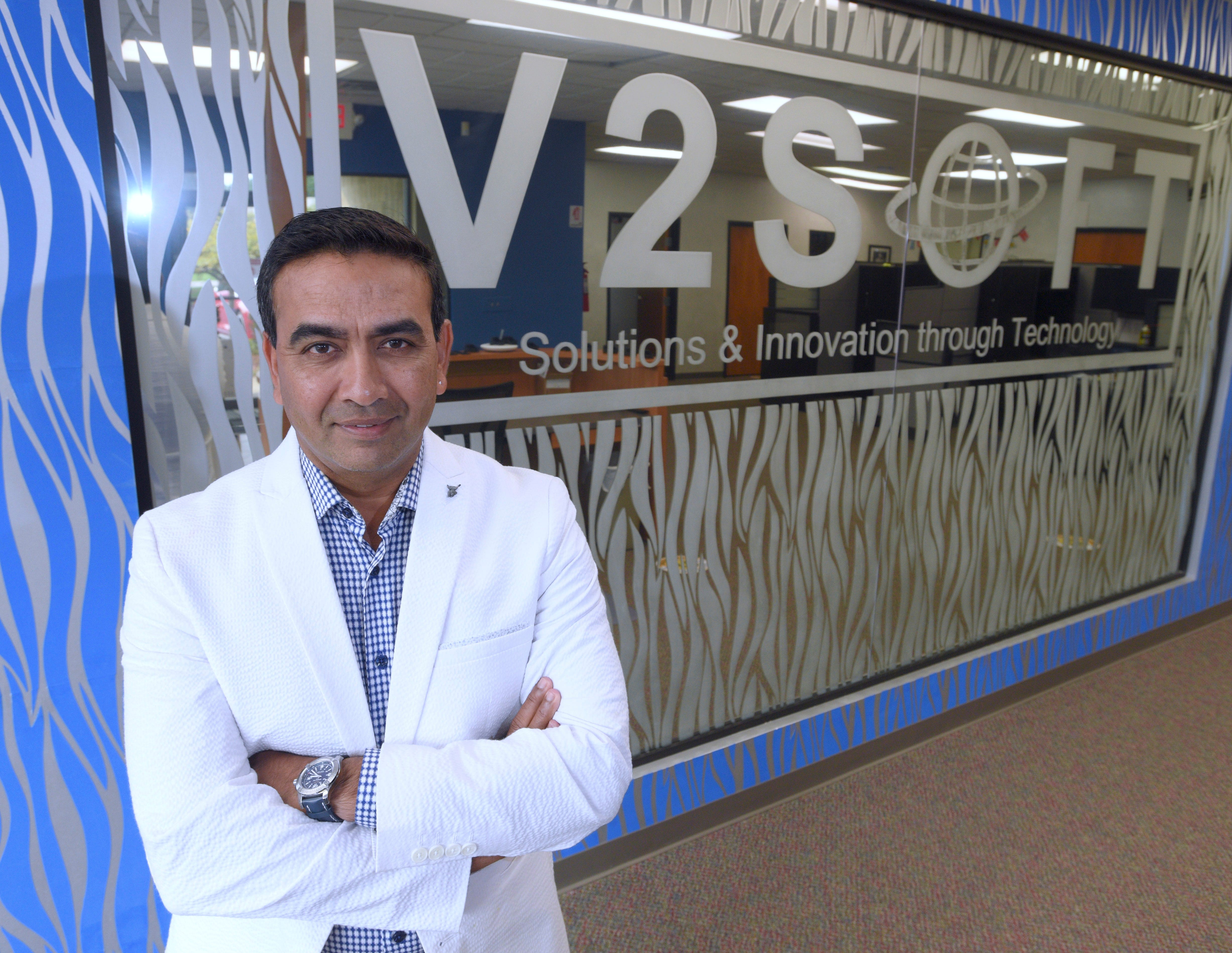 V2Soft Inc President and CEO Varchasvi Shankar, of West Bloomfield, poses at his Bloomfield Hills office, Tuesday afternoon, Sept. 15, 2020. The business is FCAs IT supplier, providing digital services. This year, during FCA's matchmaking event, V2Soft will promote 'Company TRAK,' a wearable device and tags used for contract tracing and social distancing.