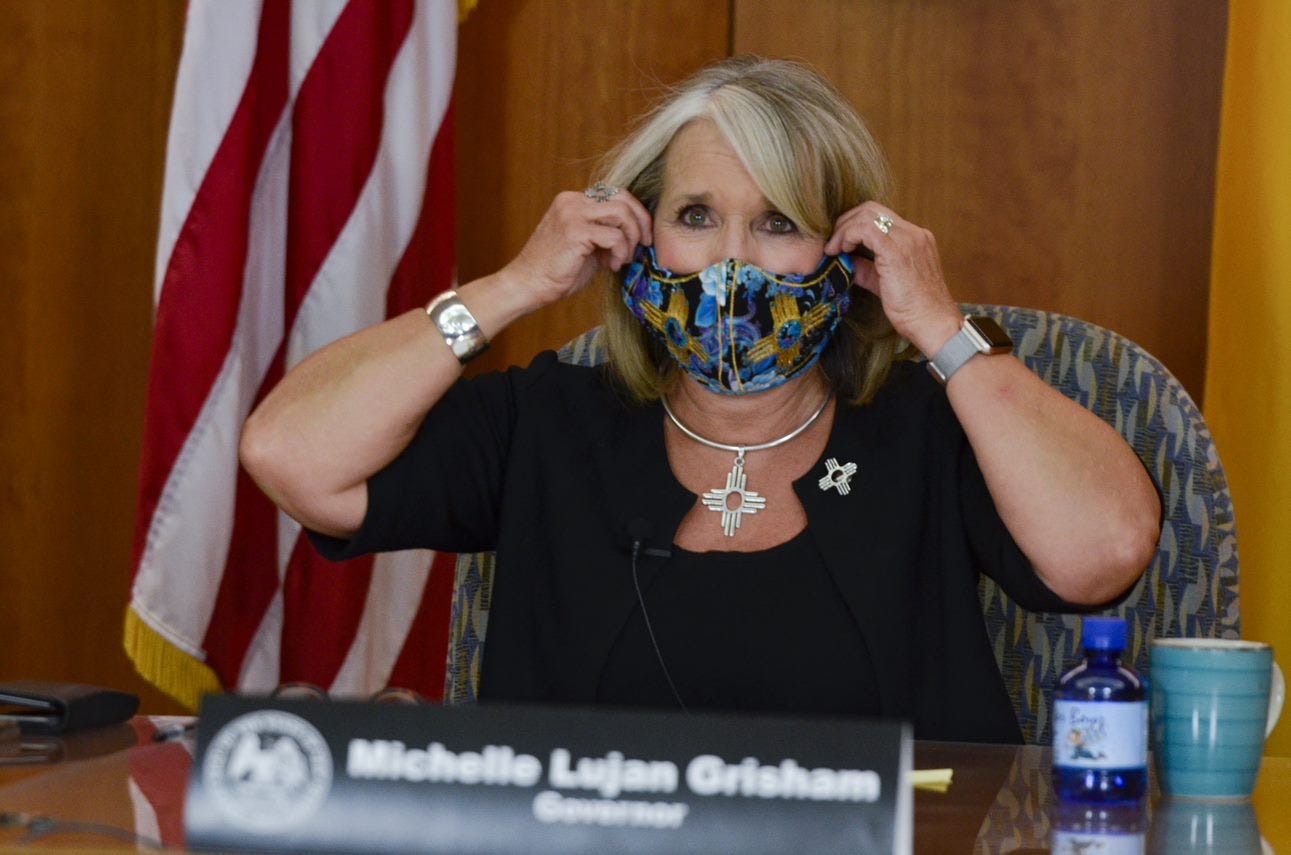 New Mexico Governor Michelle Lujan Grisham removes her face mask during a press conference livestreamed from the state Capitol building in Santa Fe on Thursday, Sept. 10, 2020.