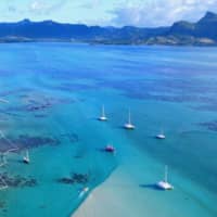 An undated photo shows oil containment booms along the coast of Mauritius following a massive oil spill. | MAURITIUS GOVERNMENT / VIA KYODO