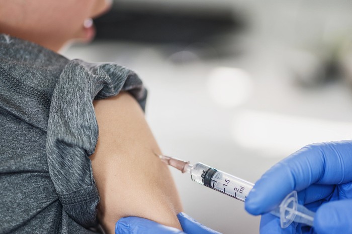 A medical provider giving a shot to a child.