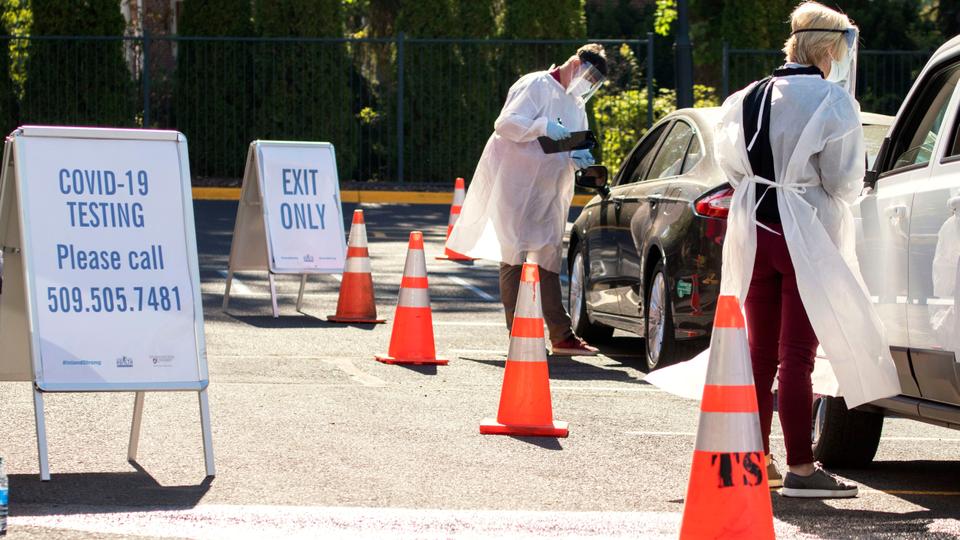 Faculty members from Washington State University Health Sciences Spokane administer Covid-19 tests to students at a mobile testing site during the coronavirus pandemic on campus, September 2, 2020.