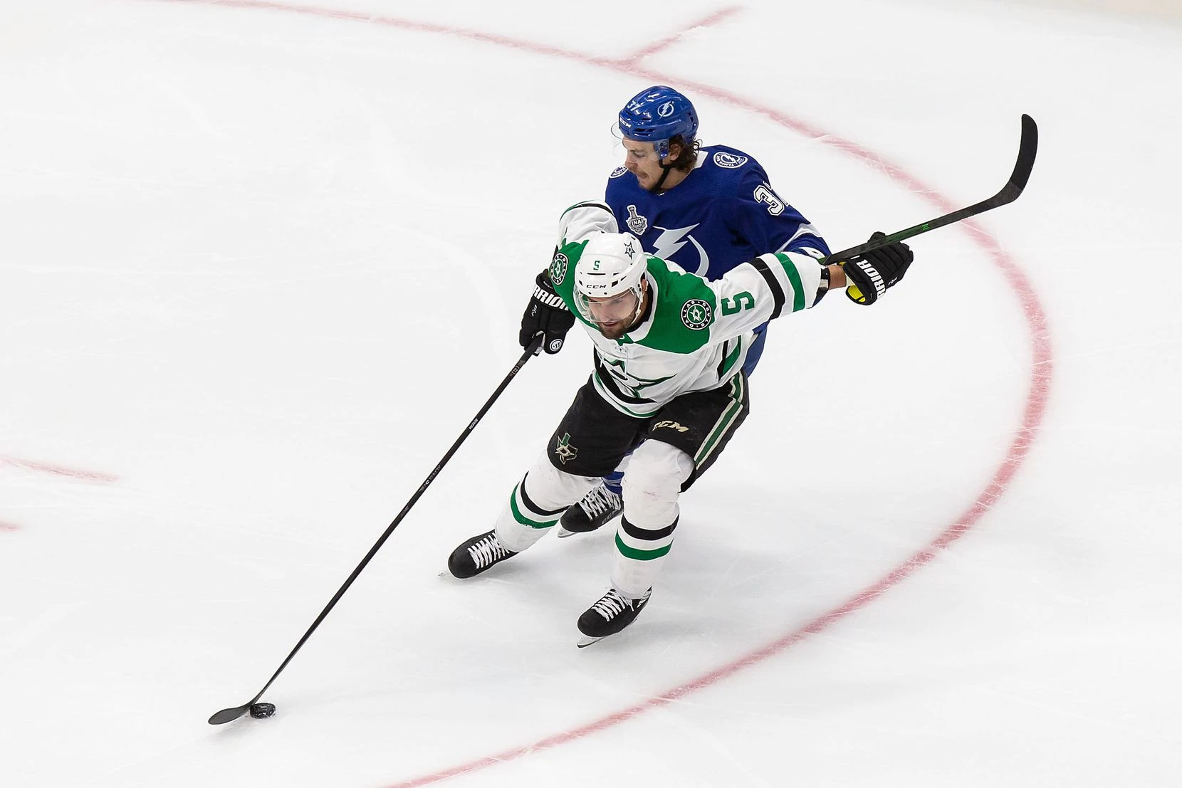 Andrej Sekera (5) of the Dallas Stars battles against Yanni Gourde (37) of the Tampa Bay Lightning during Game Two of the Stanley Cup Final at Rogers Place in Edmonton, Alberta, Canada on Monday, September 21, 2020. (Codie McLachlan/Special Contributor)