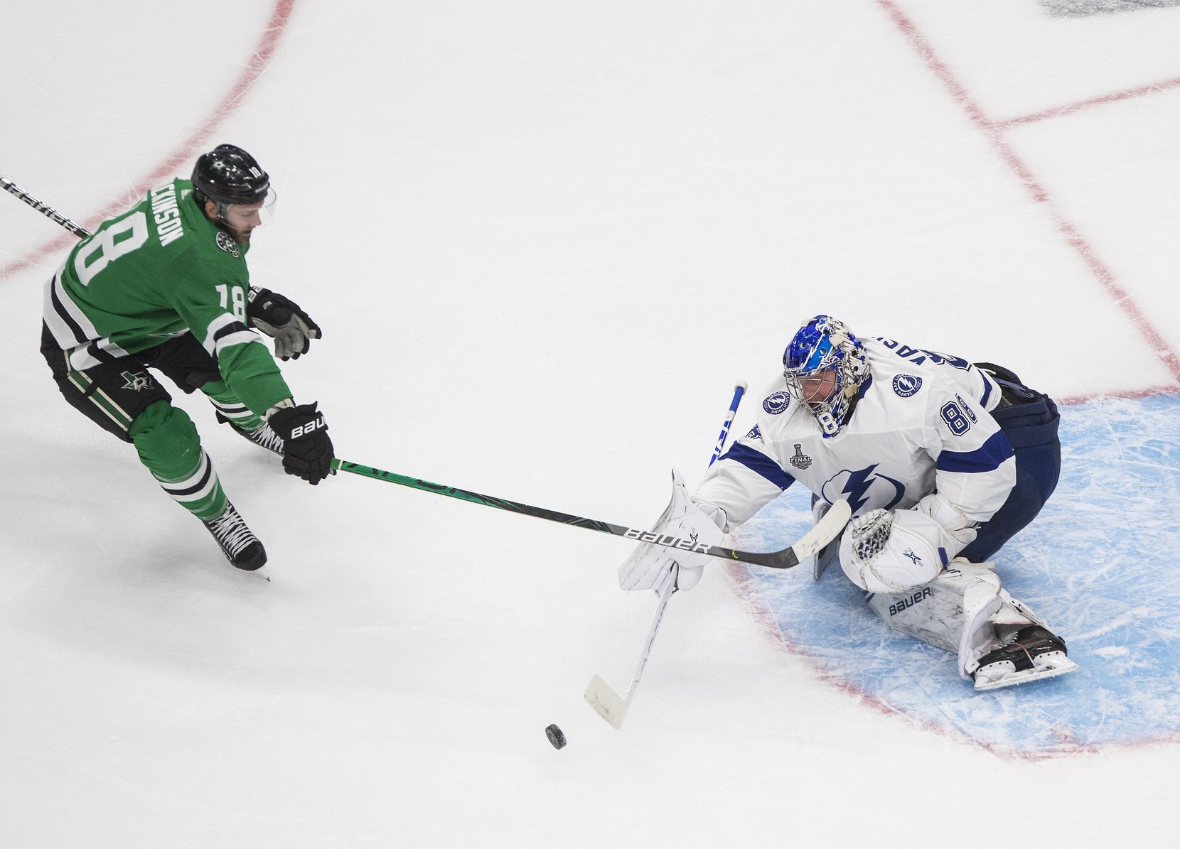 Tampa Bay Lightning goaltender Andrei Vasilevskiy (88) stops Dallas Stars center Jason Dickinson (18) during the third period of Game 3 of the NHL hockey Stanley Cup Final, Wednesday, Sept. 23, 2020, in Edmonton, Alberta. (Jason Franson/The Canadian Press via AP)