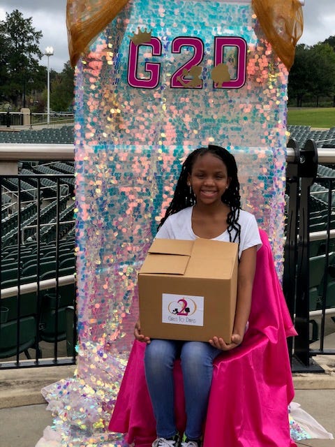 Girls 2 DIVAS members pick up their DIVA boxes for virtual meetings due to COVID-19.