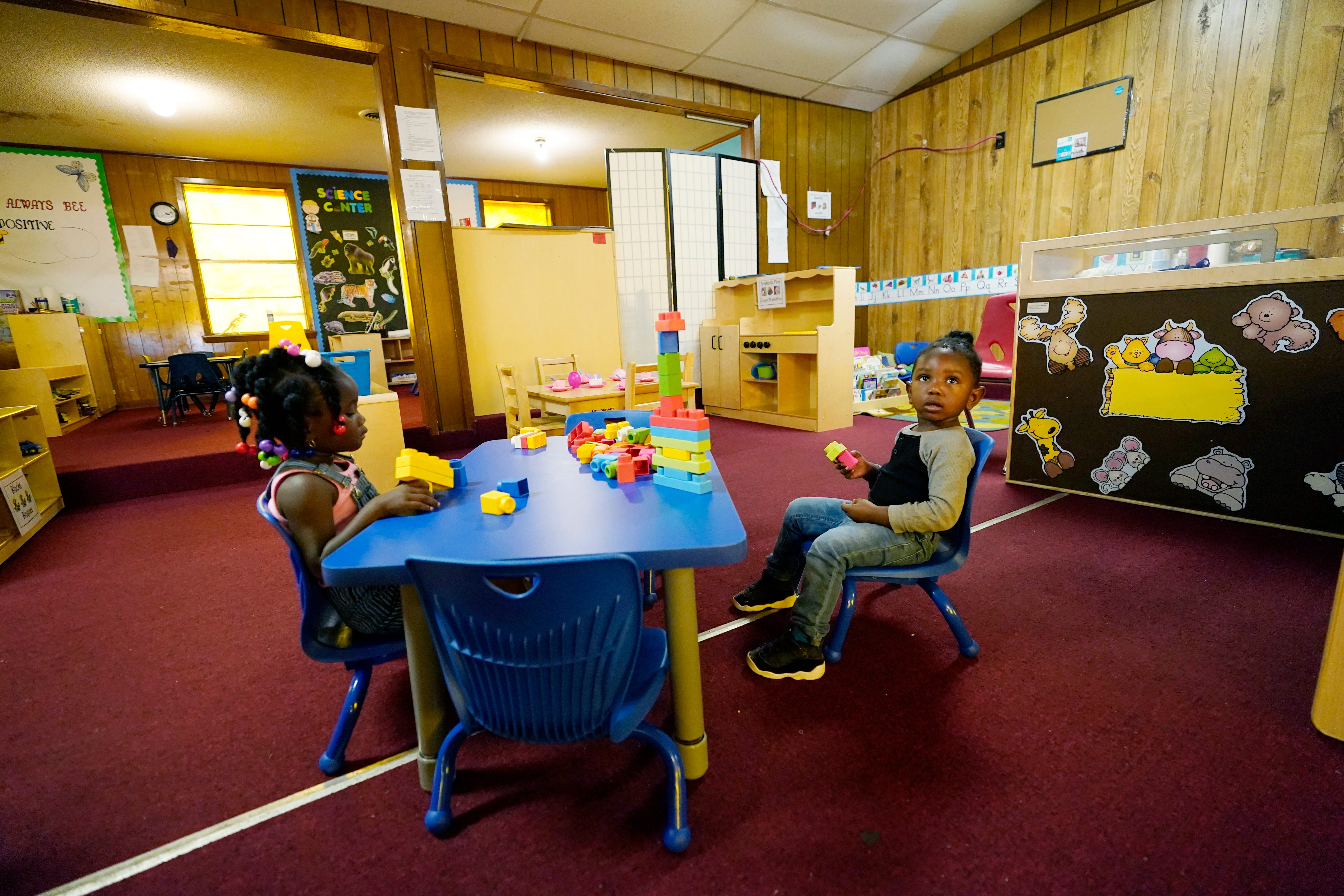 Children build a block structure in the main classroom of the School of Champions Development & Learning Academy in Itta Bena, Miss., Thursday, Oct. 22, 2020. The owner Patricia Young has spearheaded a petition signed by 300 residents asking the state auditor to launch an investigation into why they are paying what they believe is a high price for electricity from the city-run and owned utility, and yet the city has a long standing debt with the wholesale electrical provider, and is now facing complete disconnection on Dec. 1. (AP Photo/Rogelio V. Solis)