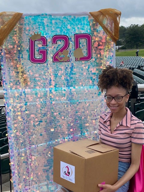 Girls pick up their DIVA boxes for virtual meetings due to COVID-19.