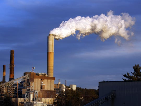 A plume of steam billows from a coal-fired power plant.