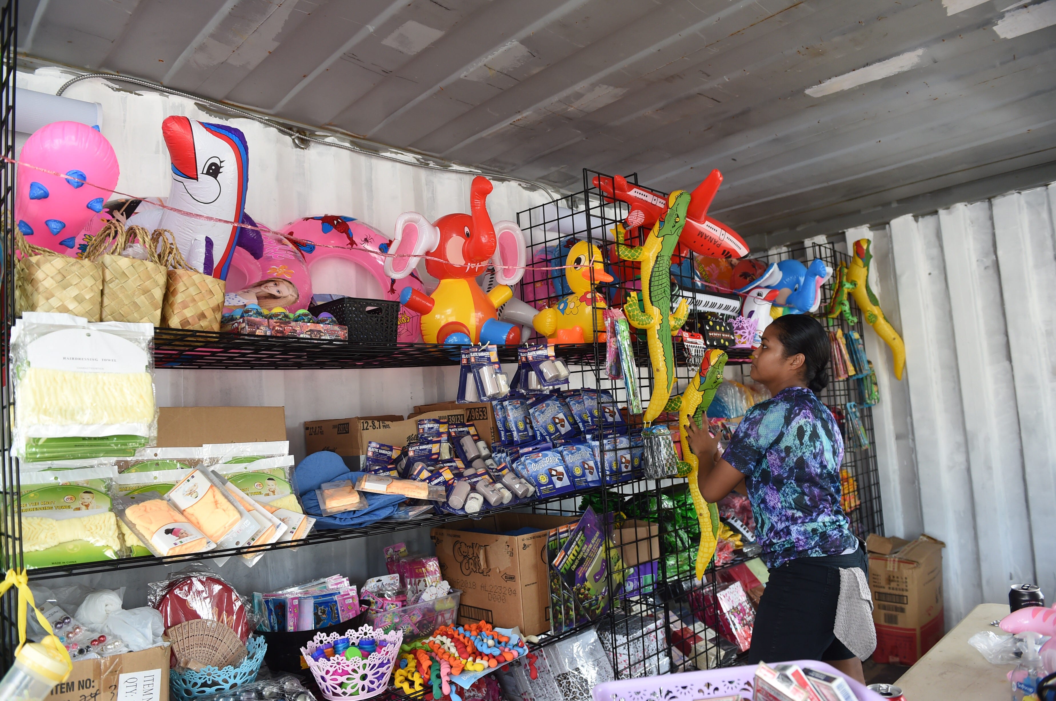 Volunteer Cassandra Towai organizes prizes at the “Spin-to-win” game booth in preparation for the opening of the 75th Liberation Carnival at Paseo de Susana Park in Hagåtña in this June 9, 2019, file photo. An audit of the 75th Guam Island Fair and Liberation Day Carnival found it didn't comply with Guam procurement rules and regulations.