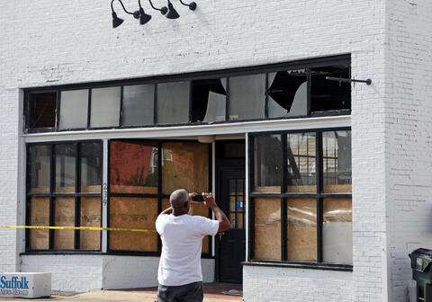 A local resident surveys building damage after Tropical Storm Isaias swept through Suffolk, Virginia, on Aug. 4, 2020. Credit: Virginia Sea Grant Natural disaster preparations may aid businesses' pandemic response
