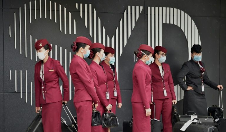 Qatar Airways crew prepare to enter Sydney international airport to fly a repatriation flight back to France on April 2, 2020, amid the COVID-19 coronavirus pandemic