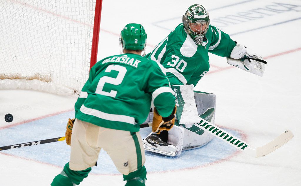 The St. Louis Blues score past Dallas Stars goaltender Ben Bishop (30) and defenseman Jamie Oleksiak (2) during the second period of an NHL matchup between the Dallas Stars and the St. Louis Blues on Friday, Feb. 21, 2020 at American Airlines Center in Dallas. (Ryan Michalesko/The Dallas Morning News)
