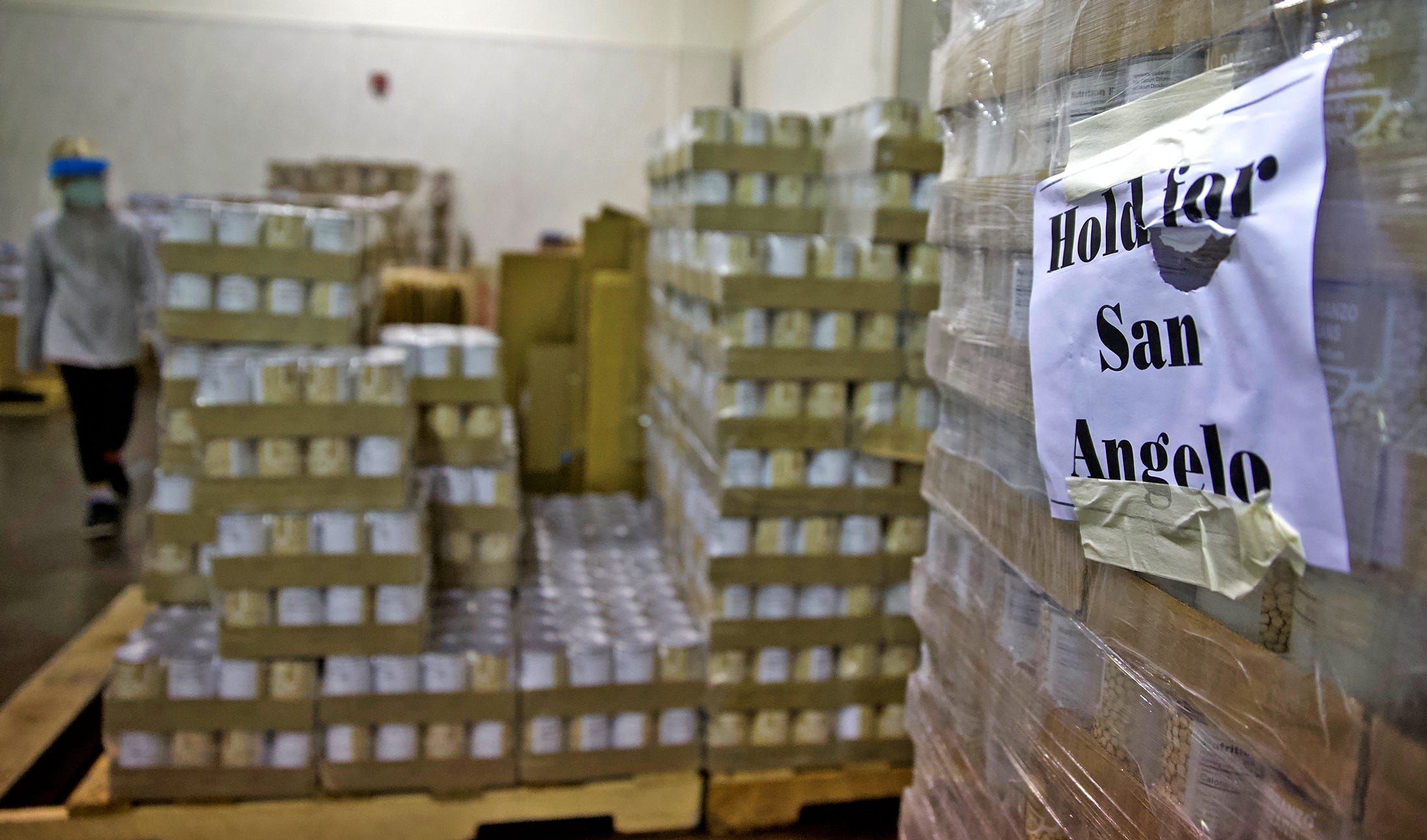 Canned goods sit stacked on pallets during a food distribution event at the St. Paul Presbyterian Church on Saturday, Nov. 21, 2020.