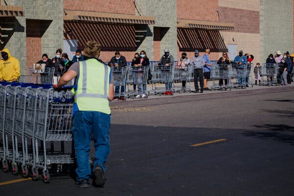 People waiting in line outside a Sam’s Club in Albuquerque this month. Supermarkets in New Mexico are being ordered to close if employees contract the virus, leaving shoppers with little recourse.