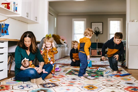 Melissa Wirt, the owner of Latched Mama, an online clothing retailer geared to nursing moms based in Midlothian, Virginia, with her five kids