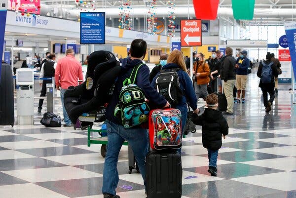 People walking through a terminal at O’Hare International Airport in Chicago on Friday.