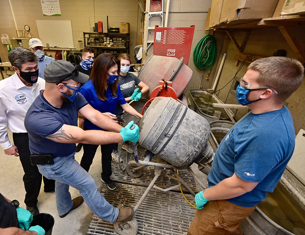 Music City Grand Prix CEO and MTSU alumnus Matt Crews, left in white shirt, observes Monday, Nov. 9, as MTSU Concrete Industry Management senior and Missouri native Cody Gange, center left, and lab assistant and senior T.J. Paul of Readyville, Tenn., right, assist concrete industry professor Heather Brown, center, with making an eco-friendly concrete mix inside a lab in the Voorhees Engineering Technology Building on the Murfreesboro, Tenn., campus. The mix will be tested for use in race barriers for the August 2021 race in downtown Nashville. In the background, from left, are alumnus Denny Lind of Master Builders Solutions, and MTSU senior Concrete Industry Management majors Austin Gaydosh of Rockvale, Tenn., and Autumn Gates of Murfreesboro. MTSU and the Grand Prix signed a memorandum of understanding Monday formalizing their partnership in support of the event.