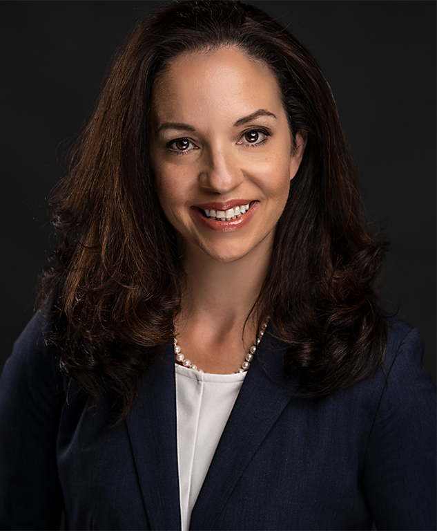 Headshot of Kathleen Fabrizi in a studio on a dark background