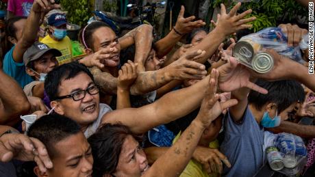 Residents affected by Typhoon Vamco scuffle over relief goods on November 14, 2020 in Rodriguez, Rizal province, Philippines.