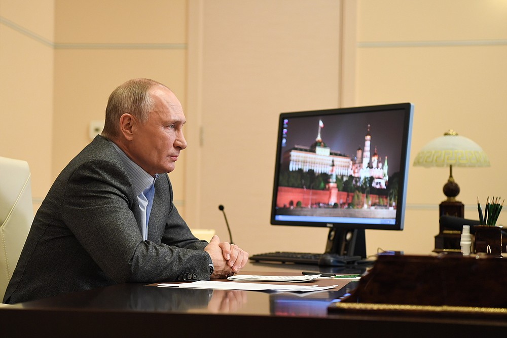 Russian President Vladimir Putin attends a meeting with participants of the We Are Together nationwide volunteer campaign via video conference at the Novo-Ogaryovo residence outside Moscow, Russia, Saturday, Dec. 5, 2020. (Alexei Nikolsky, Sputnik, Kremlin Pool Photo via AP)