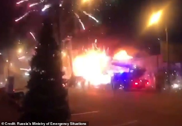 Chaotic explosions of pink, green, red and gold sparklers and firecrackers lit up the night sky as flames engulfed the trade pavilion below