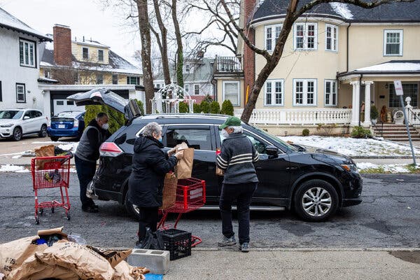 Volunteers preparing food for families in need in Newton Centre, Mass. Two federal unemployment programs are set to expire, potentially leaving millions vulnerable to eviction and hunger.