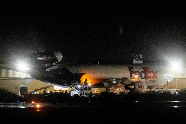 Shipping containers holding the Pfizer-BioNTech Covid-19 vaccine are unloaded at Luis Munoz Marin International Airport in San Juan early on Monday.