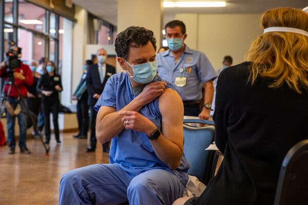 Dr. Christian Arbelaez, an emergency room physician, was the first to be vaccinated at Rhode Island Hospital in Providence on Monday.
