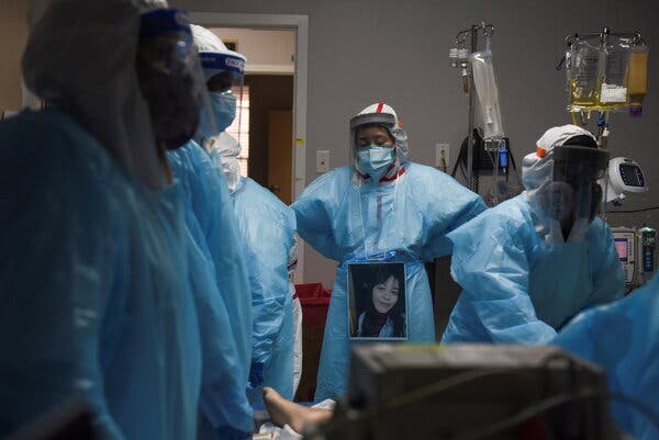 Health care workers surrounding a patient who died from Covid-19 at United Memorial Medical Center in Houston on Saturday.
