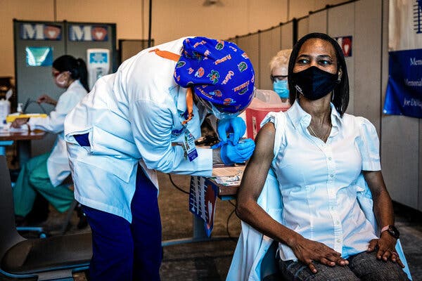 Registered nurse Cheryl Birmingham, left, administered the Pfizer-BioNtech Covid-19 vaccine to registered nurse La Tanya Forbes at a pharmacy in Miramar, Fla. on Monday.