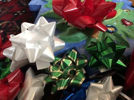 Bows retrieved from Christmas presents. These can't go into paper recycling, but can easily be saved and reused with a quick bit of tape on the back.