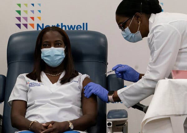 Sandra Lindsay, a nurse at Long Island Jewish Medical Center, getting the first COVID-19 vaccine from Dr. Michelle Chester at Long Island Jewish Medical Center in New Hyde Park, N.Y., on Monday.