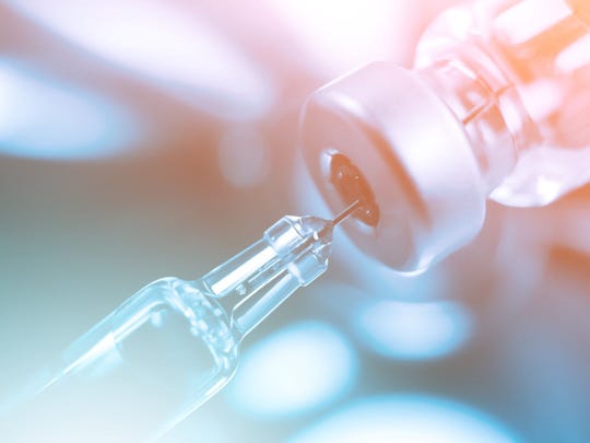Vaccine bottle with syringe and needle