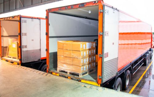 Semi-trucks parked at a loading dock