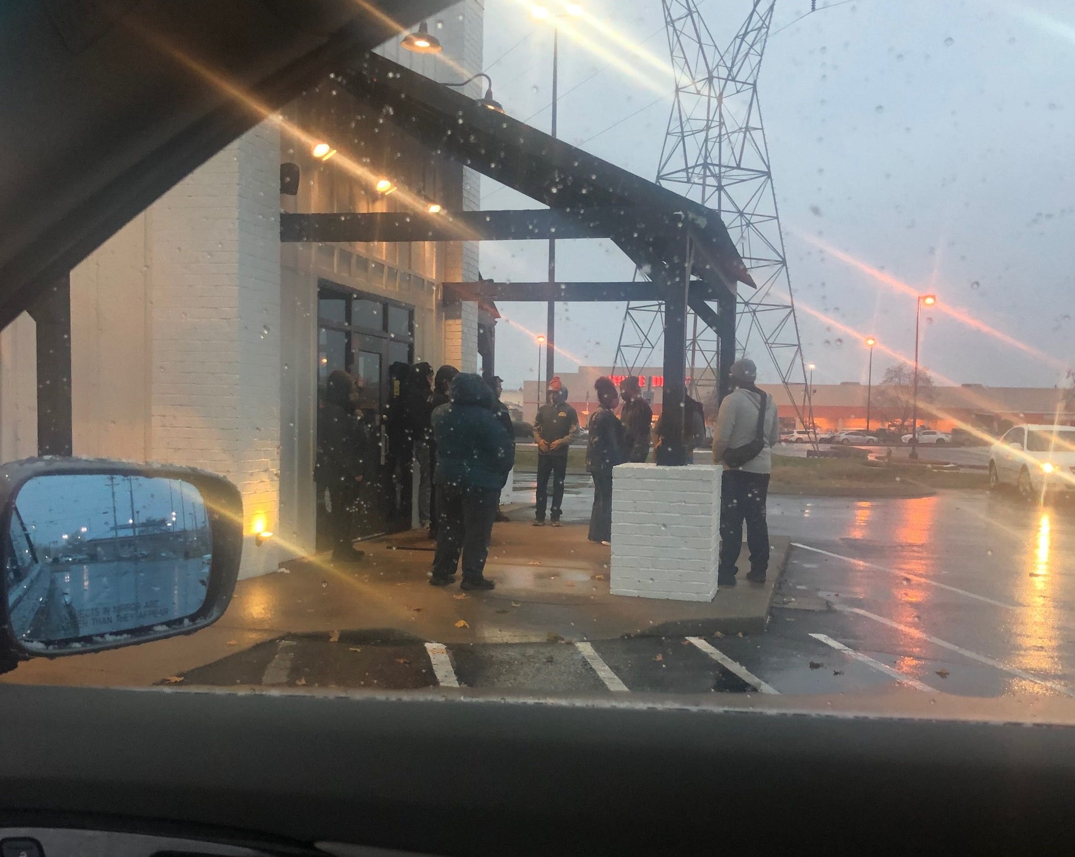 Employees of Pepper+Peach Hot Chicken wait outside the Murfreesboro store on Monday, demanding payment for lost wages.