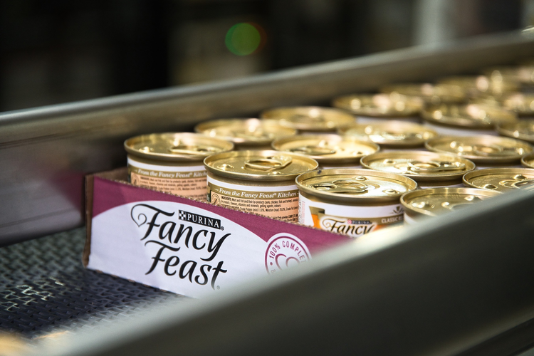 Nestle Purina Fancy Feast cat food on conveyor belt.