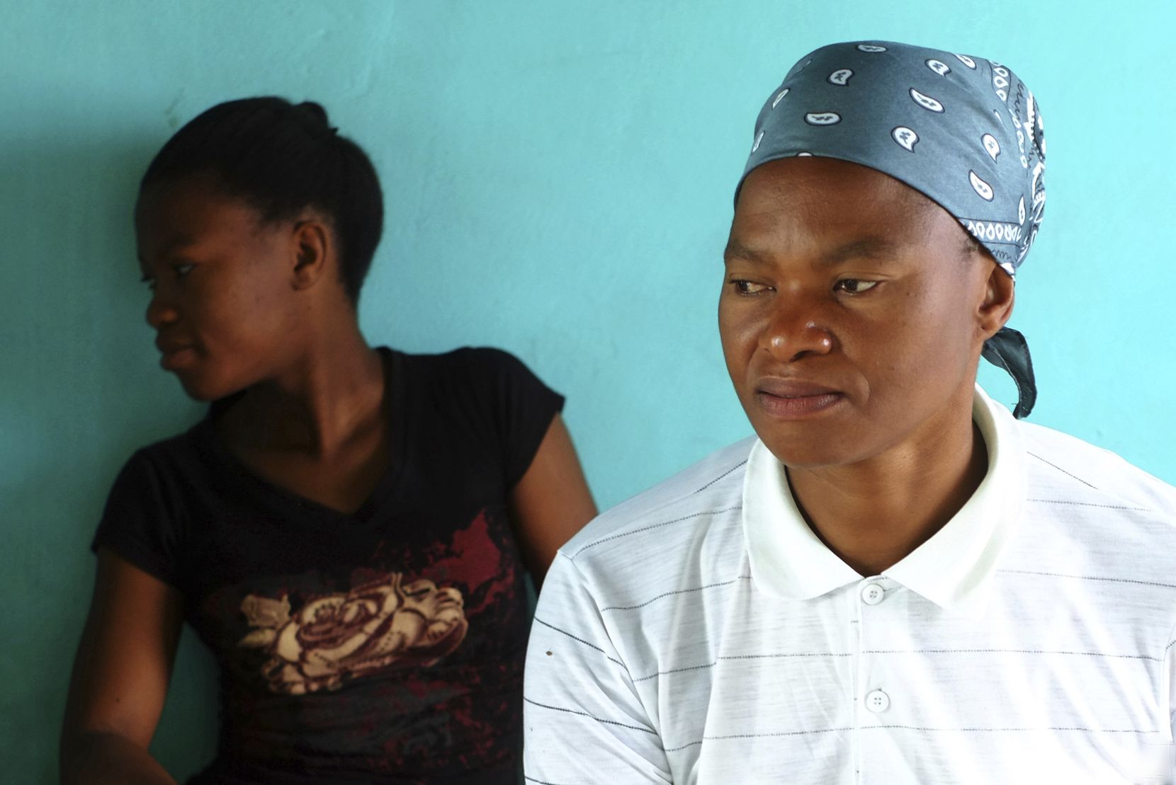 Matefo Litali, 53, a Lesotho garment worker, and her 20-year-old daughter, Refiloe, sit together in their shared room in the town of Ha Thetsane, Maseru, Lesotho, on Dec. 11.
