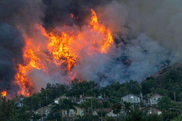 Flames rise near homes during the Blue Ridge fire on Oct. 27 in Chino Hills,