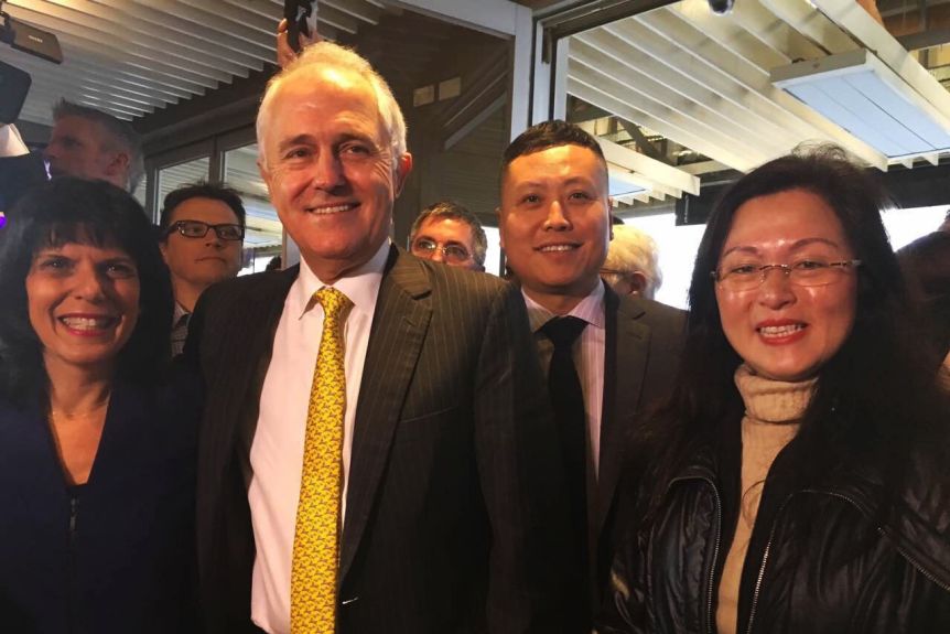 Mr Haha Liu stands behind Julia Banks, Malcolm Turnbull and Gladys Liu in 2016.