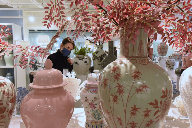 Martha Schneider, owner of La Maison in Raleigh, N.C., looks over items at Atlanta Market at AmericasMart Wednesday. Atlanta is hoping the city's events and convention business will rebound from the coronavirus, which shut down meetings for much of 2020. (Hyosub Shin / Hyosub.Shin@ajc.com)