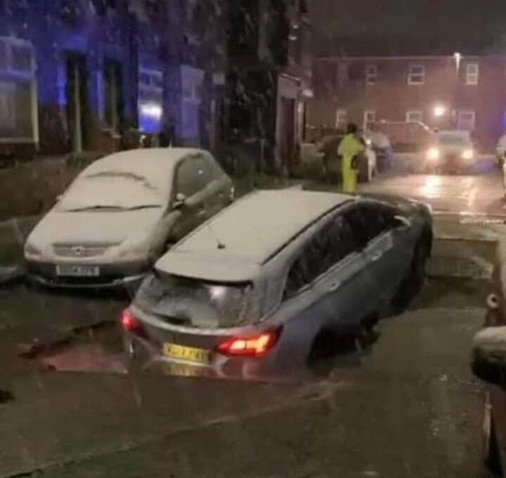 A car fell into a very large pothole in Abbey Hey, Manchester last night amid heavy snowfall