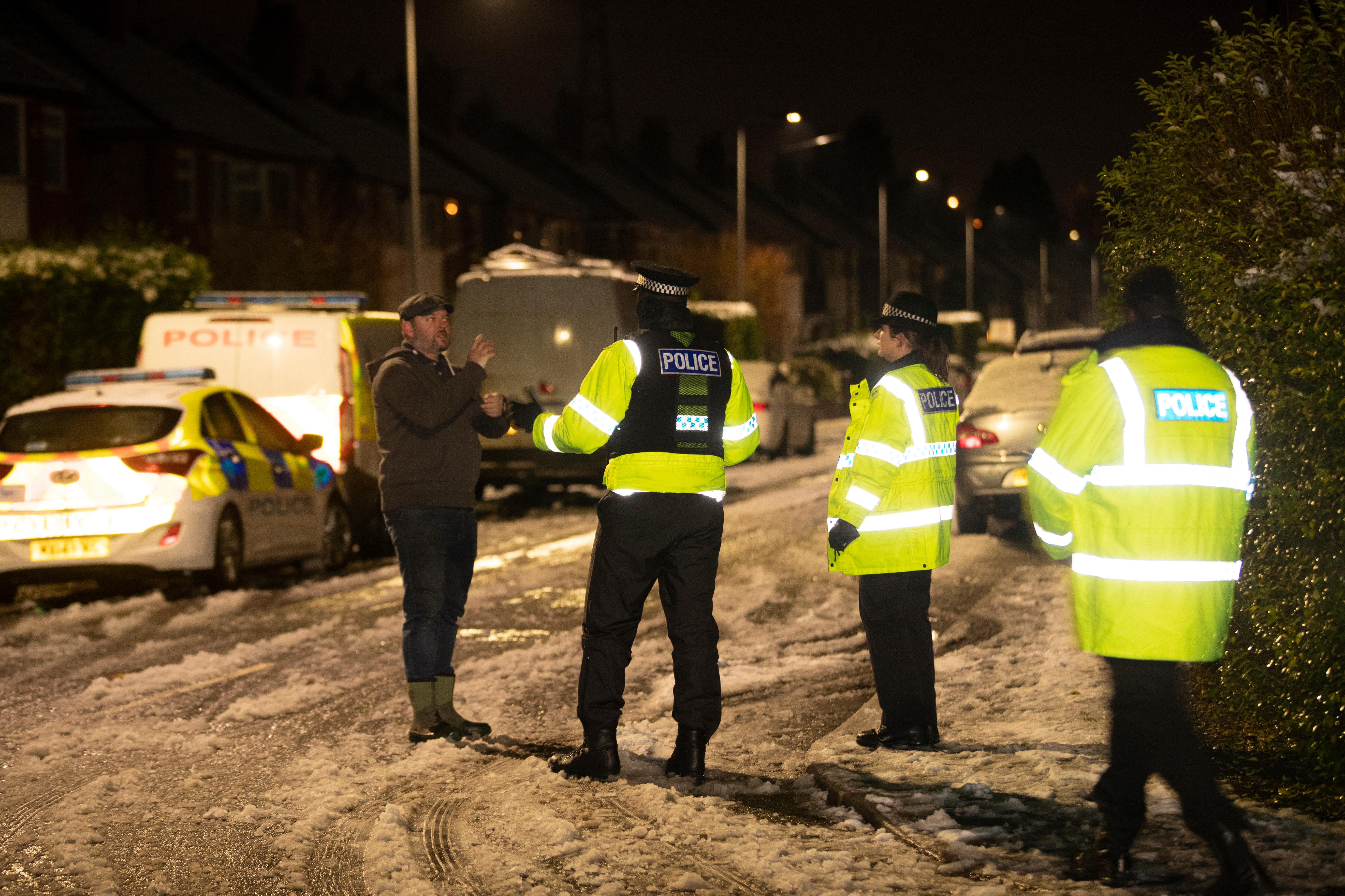 Police officers talk to a resident in the street in Didsbury as locals were evacuated in the early hours of the morning